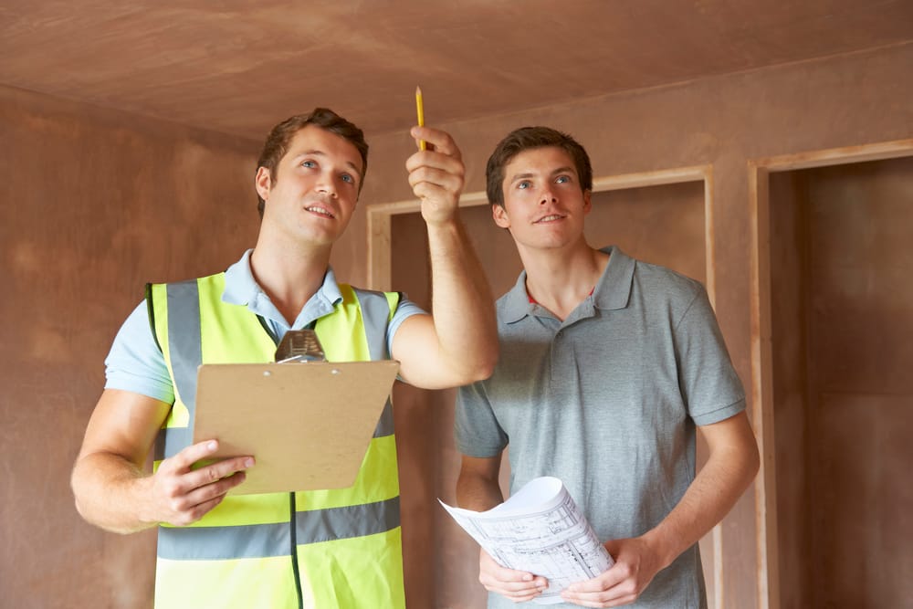 Builder And Inspector Looking At New Property Builder and inspector looking at new property